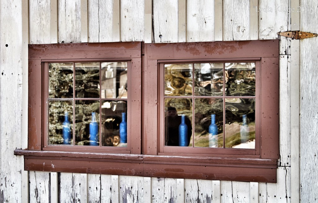 Blue bottles lined up in the window of High West distillery.