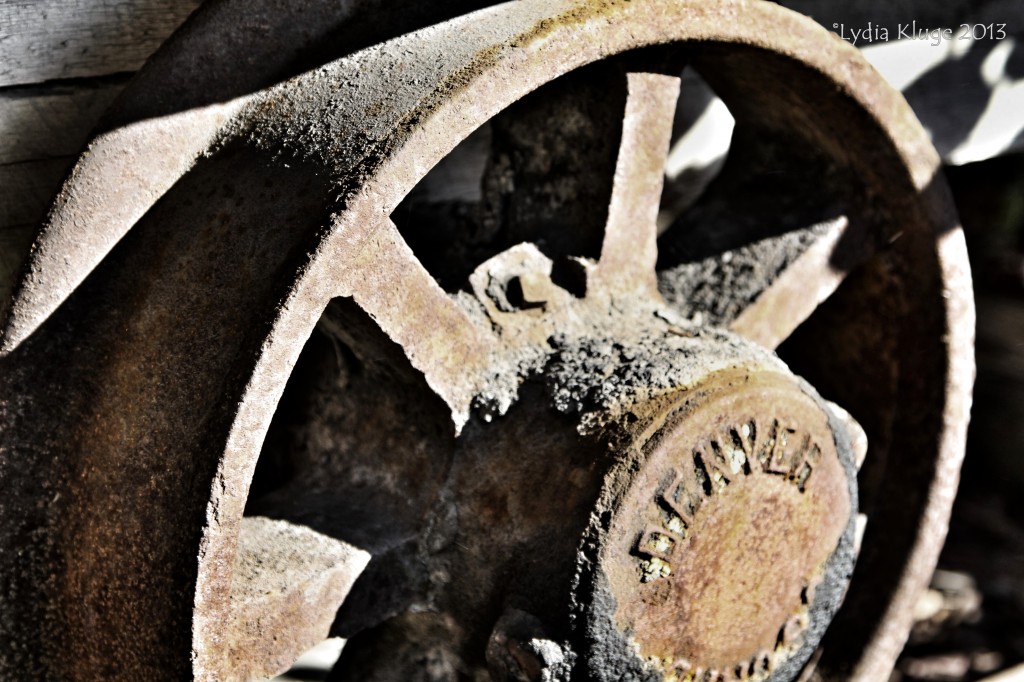 The rusty wheel of a disused mine cart.