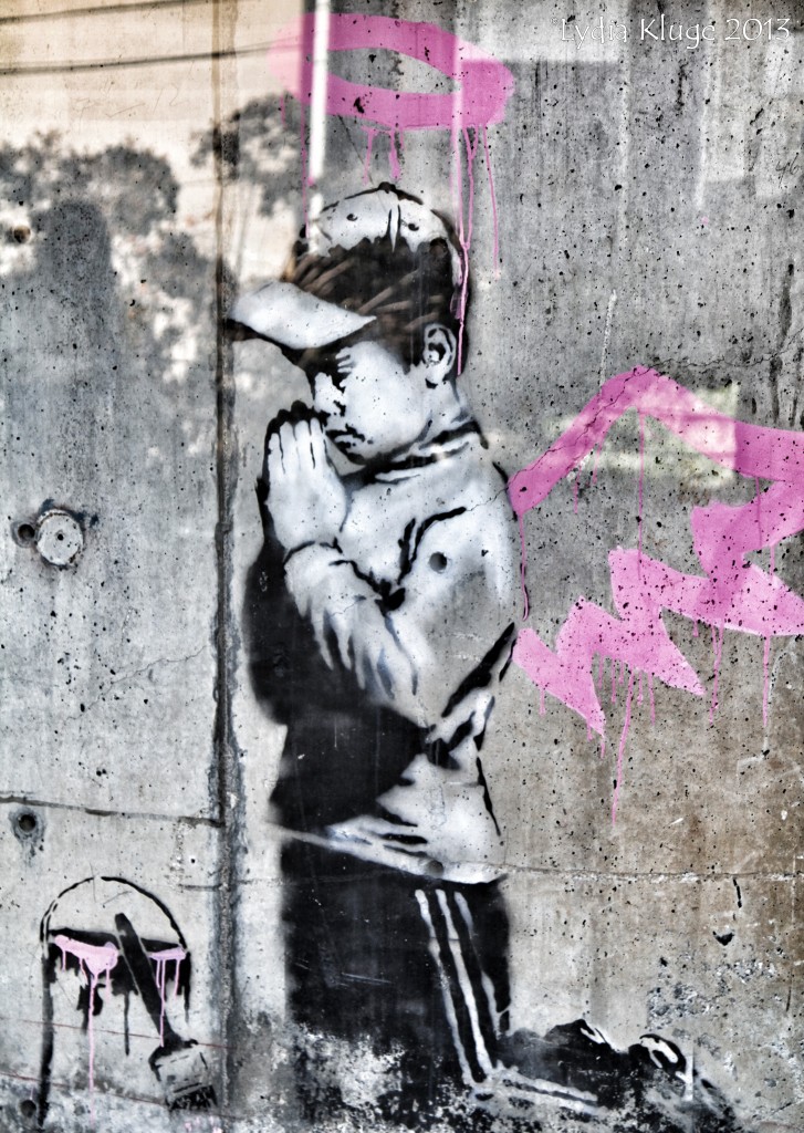 The work of English graffiti artist Banksy brightens a wall in Old Town.