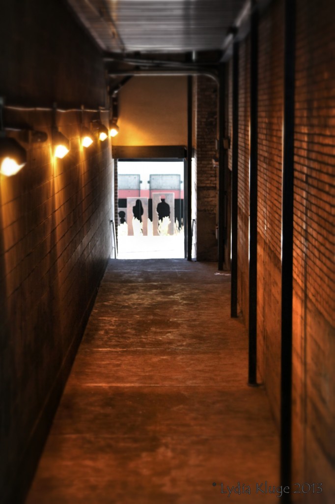 Cut out figures align with the end of an alleyway.