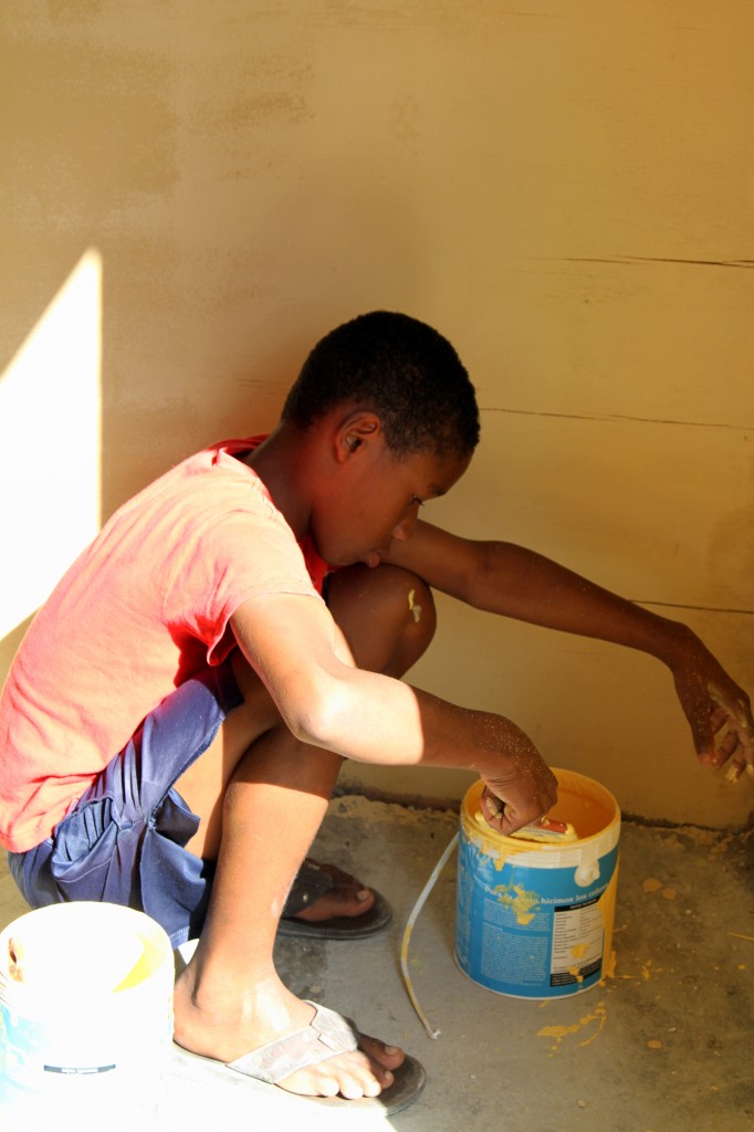 A student helps with the painting.